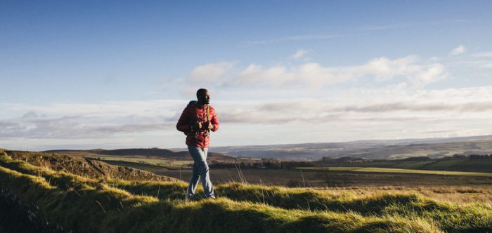 A man walking alone on a sunny day