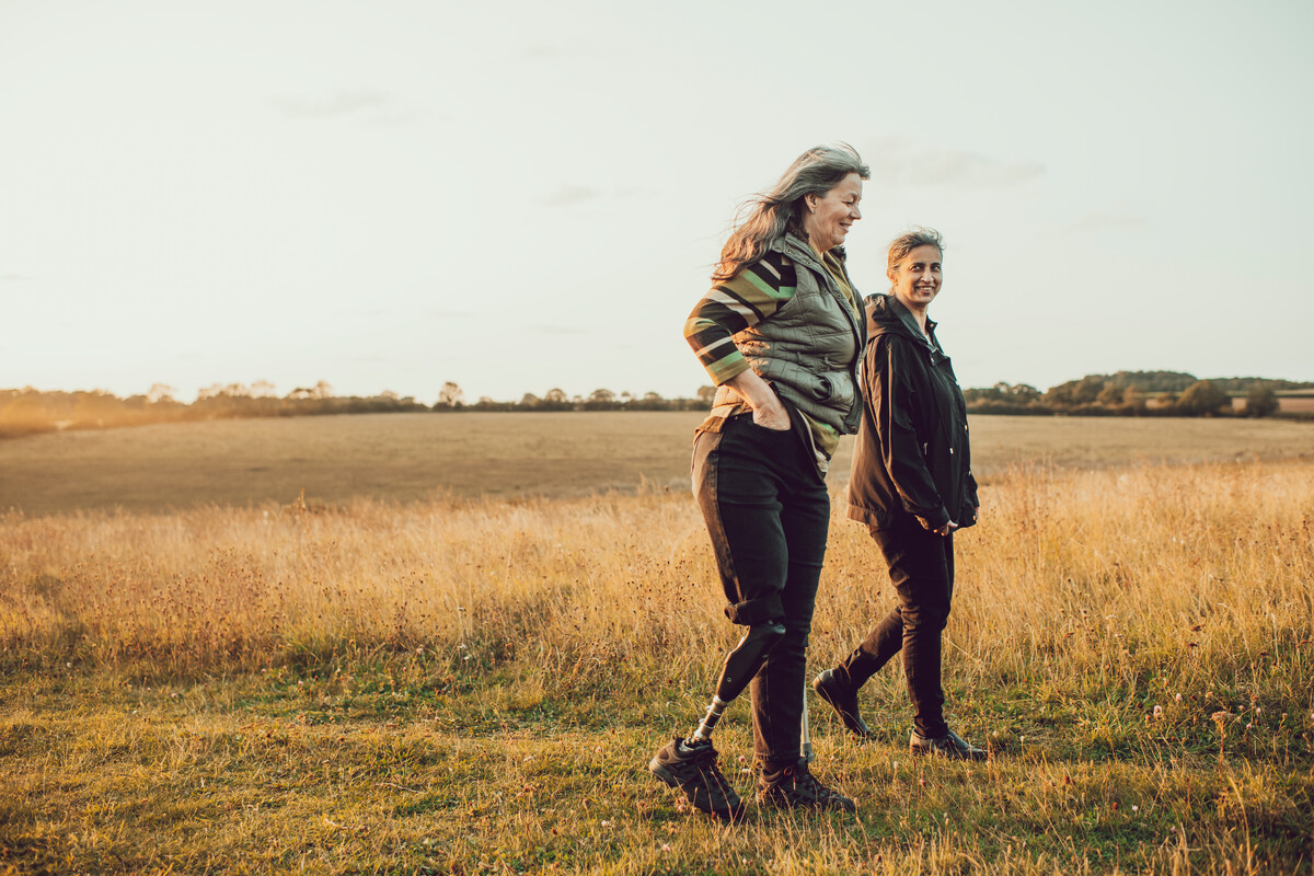 Two women walking in the countryside on a summer evening